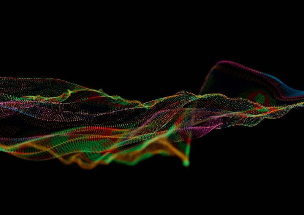 Abstract digital wave of glowing multicolored particles against a dark background, illustrating fluid data drift and probabilistic behavior in an LLM pipeline.