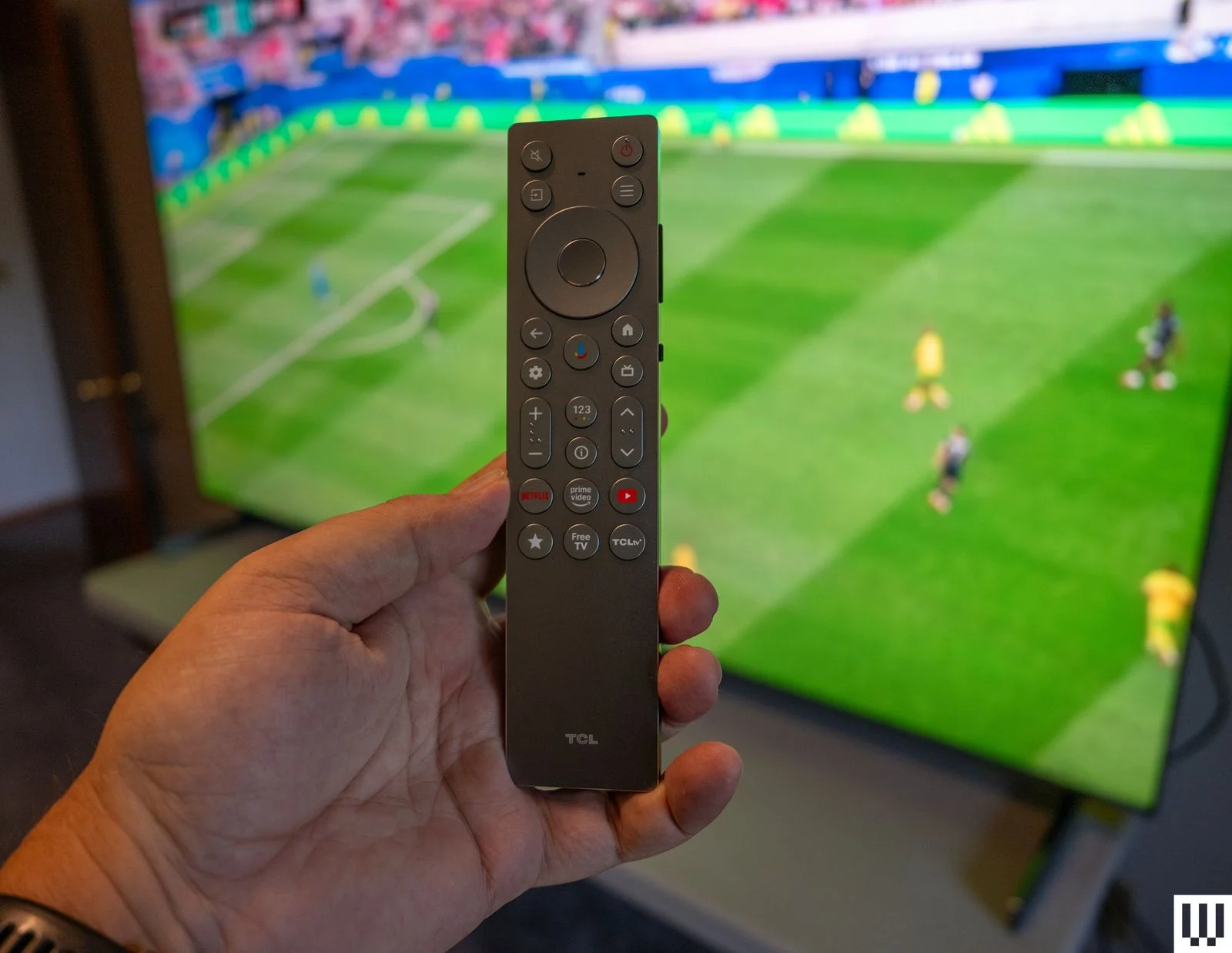 Image may contain Electronics Remote Control and Person