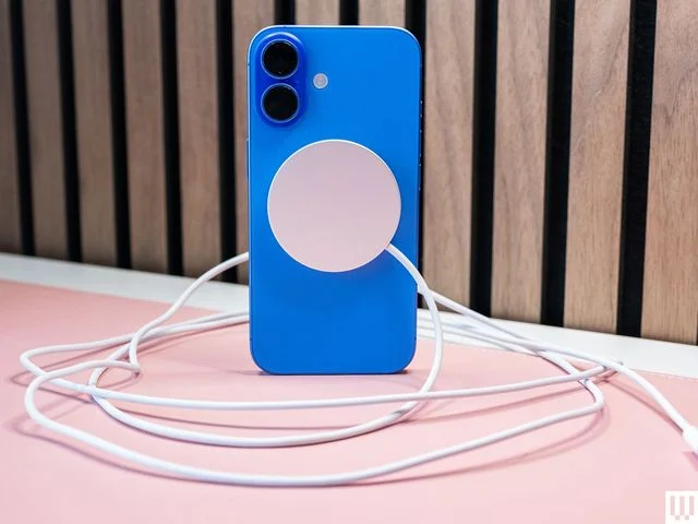 Apple MagSafe Charger  a blue mobile phone case with silver disc in the center with a cord coming from it