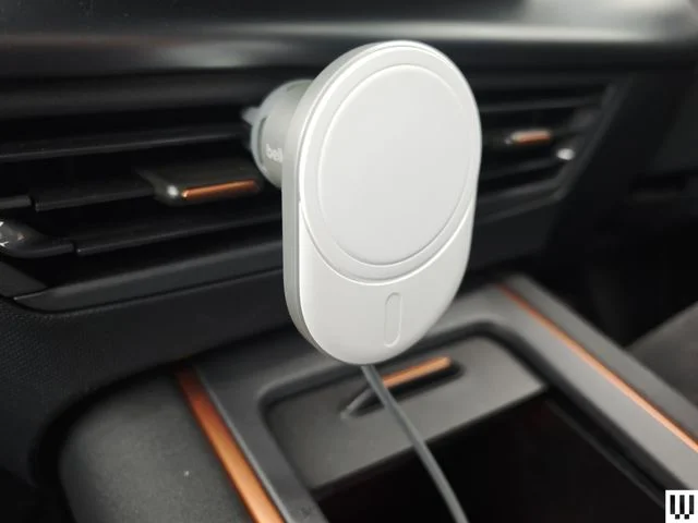 Oval shaped phone mount clipped to the vent inside a car