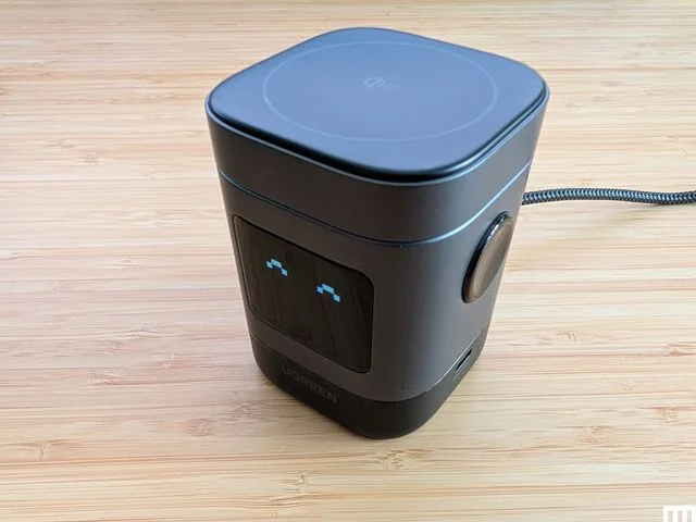 Front view of UGreen Uno 2in1 Magnetic Wireless Charger a black rectangular device with the digital screen showing a...