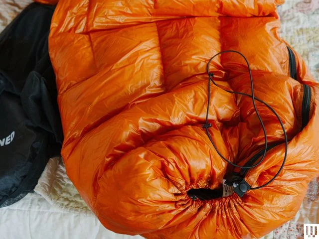 Closeup of orange puffy quilt zipped up