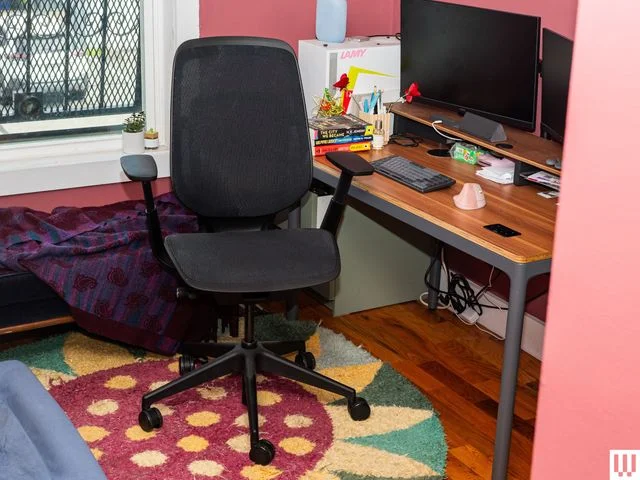 Image may contain: Furniture, Chair, Indoors, Home Decor, Rug, Computer, Computer Hardware, and Computer Keyboard