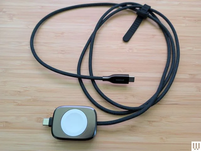 Nomad Universal Cable for Apple Watch connected to a small square device for charging a watch