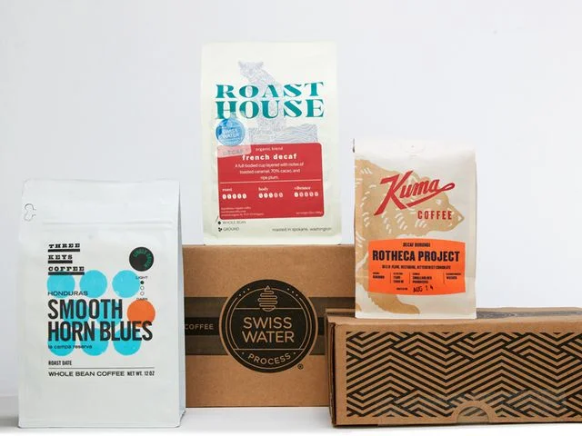 Left: Coffee bag on white surface. Center: Coffee bag sitting on cardboard box. Right: Coffee bag sitting on cardboard box with wave pattern.